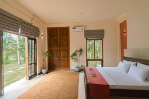 a bedroom with a bed and a sliding glass door at Welpalla Signature in Welpalla