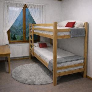 two bunk beds in a room with a window at LES TOURISTES in Le Chatelard