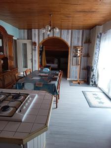 a kitchen and dining room with a table and a stove at Chez Sylvia in Saint-Julien-du-Pinet