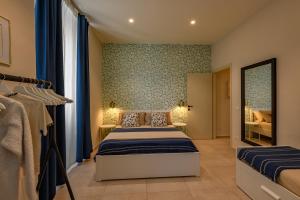 a bedroom with two beds and a mirror at Bastioni Central Apartment in Civitavecchia