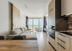a living room with a couch and a living room with a tv at The Seaview Jacuzzi Suite by PS in Golem