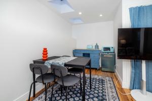 a small kitchen with a table and four chairs at Huh's Lodge in San Francisco