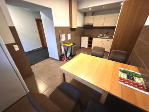 a kitchen with a wooden table and chairs at Pension Am Pilgerbach in Baunatal +19 photos