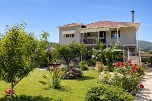 a house with a garden in front of it at Liovore Apartments in Lygia