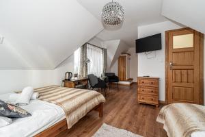 a bedroom with a bed and a desk at Willa u Baranów 2 in Zakopane