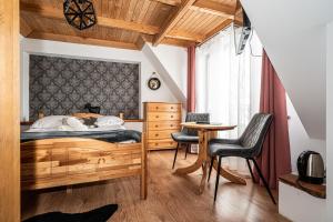 a bedroom with a bed and a table and chairs at Willa u Baranów 2 in Zakopane