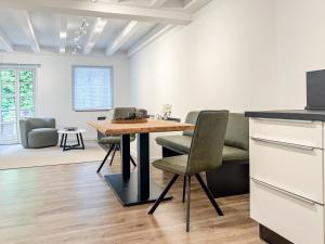 a kitchen and dining room with a table and chairs at Gutshaus am Rhein in Düsseldorf