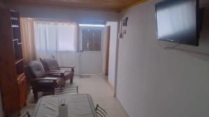 a living room with a flat screen tv on a wall at Cabaña Mailin II in Uspallata