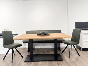 a dining room table with two chairs and a wooden table at Gutshaus am Rhein in Düsseldorf +2 photos