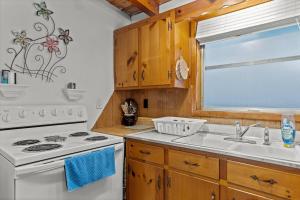 a kitchen with a white stove and a sink at Pool, Blocks away from Beach, Dog friendly in Oak Island +47 photos