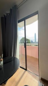 a room with a large glass door to a balcony at FK studio in Abidjan