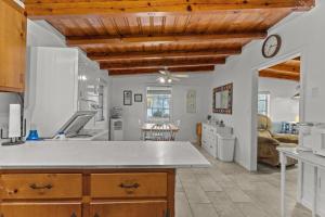 a kitchen with wooden ceilings and a large kitchen counter at Pool, Blocks away from Beach, Dog friendly in Oak Island