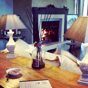 a table with a vase on it with a fireplace at Agriturismo Sugheretello in Semproniano