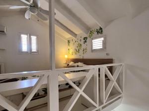 a white room with a bed and a ceiling fan at Habitat Samaná Apartments - Coral Samanà in Los Corozos +5 photos