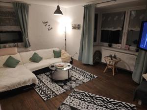 a living room with a couch and a table at Apartment For You in Hameln