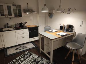 a kitchen with a desk and two chairs in it at Apartment For You in Hameln