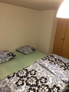 a bedroom with two beds and two pillows at Lille værelse på 1 sal in Kolding