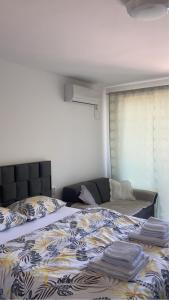 a bedroom with a bed with a blanket on it at Apartman studio BMB 1 in Bukorovac