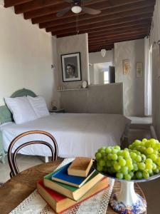 a room with a bed and a table with books at Casa Mariscal Polopos in Polopos