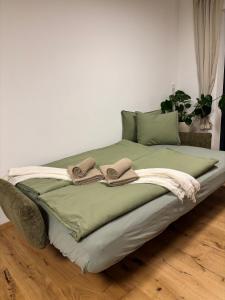 a bed with two slippers on top of it at Apartment Leitner in Haiming