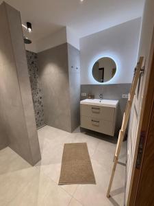 a bathroom with a sink and a mirror at Apartment Leitner in Haiming +9 photos