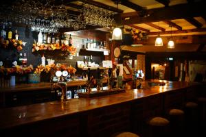 a bar with a wooden counter top in a restaurant at Ye Olde Crown in Edenbridge