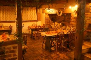 a dining room with a table and chairs and a fireplace at Ye Olde Crown in Edenbridge +19 photos