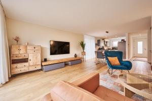a living room with a couch and a flat screen tv at Chalet in Thun, modern, spacious, perfect location in Thun