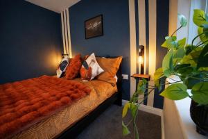 a bedroom with a bed with an orange blanket at Preston Central in Preston