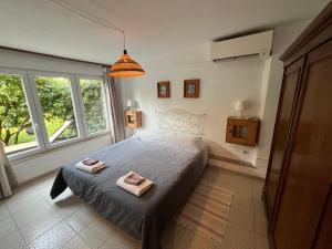 a bedroom with a bed with two towels on it at Casa Furrer in Tirrenia