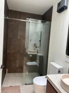 a bathroom with a shower with a toilet and a sink at Charlie Browns Clyde Studio in Clyde