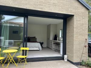 a room with sliding glass doors and a bedroom at Charlie Browns Clyde Studio in Clyde +6 photos