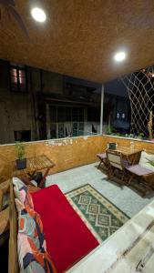a patio with a table and a red carpet at Moosica Hostel in Tbilisi City