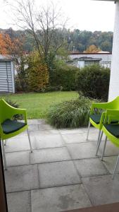 two green chairs sitting on top of a patio at A&M Wohnen2 in Ravensburg