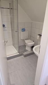 a bathroom with a shower and a toilet and a sink at Privatzimmer Hagen in Hagen