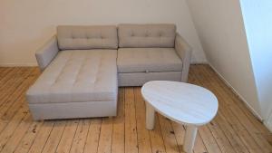 a living room with a couch and a table at Privatzimmer Hagen in Hagen +67 photos