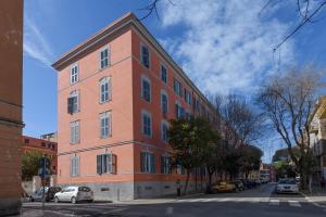 a large brick building on a city street at Bastioni Central Apartment in Civitavecchia