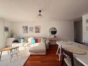 a living room with a couch and a table at Le cocon des familles - 2 Chambres in Vannes
