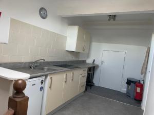 a kitchen with a sink and a counter top at Azalea apartments top floor in Sunderland