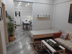a living room with a couch and a table at G&G home 2 in Kalamata