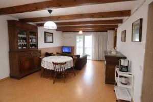 a living room with a table and a couch at Casa Furrer in Tirrenia