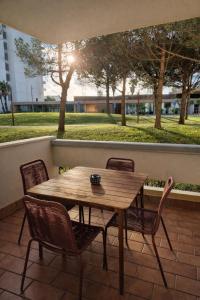 a wooden table and chairs on a patio at Casa do Zimbro in Troia