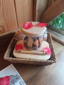 a glass jar with flowers on top of a table at Ptit Ranch "Ô Rêves Atypiques" spa privatif in Boucé +24 photos