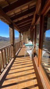 a wooden deck with a table and chairs on it at Allotjaments rurals Can Punti in Vallfogona de Ripolles