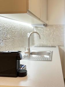 a toaster sitting on a kitchen counter next to a sink at Mediterranean in Preveza +58 photos