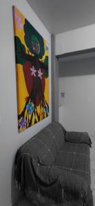 a bed in a room with a painting on the wall at Pousada Familiar 09 in Rio do Sul