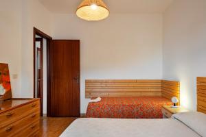 a bedroom with a bed and a wooden headboard at Villetta Patitari in Gallipoli