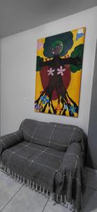 a bed in a room with a painting on the wall at Pousada Familiar 09 in Rio do Sul +2 photos