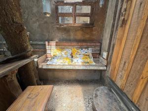 a small bed in a room with a window at Chalé João de barro in Bonito