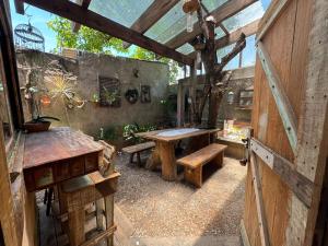 an outdoor patio with a wooden table and benches at Chalé João de barro in Bonito